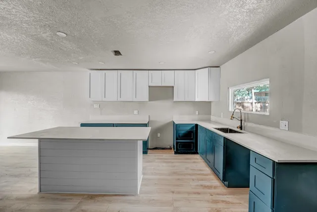 a kitchen with a sink cabinets and window