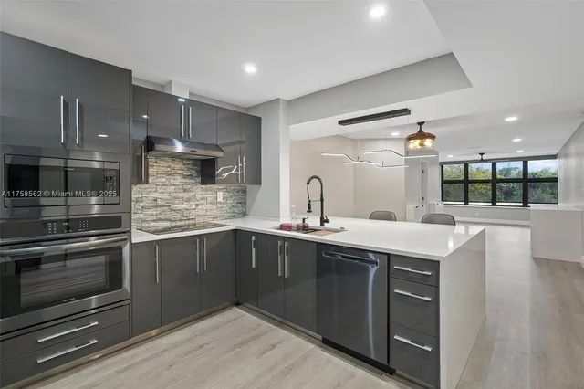 a kitchen with a sink and stove