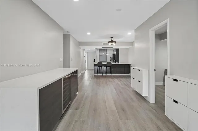 a view of living room with furniture and wooden floor