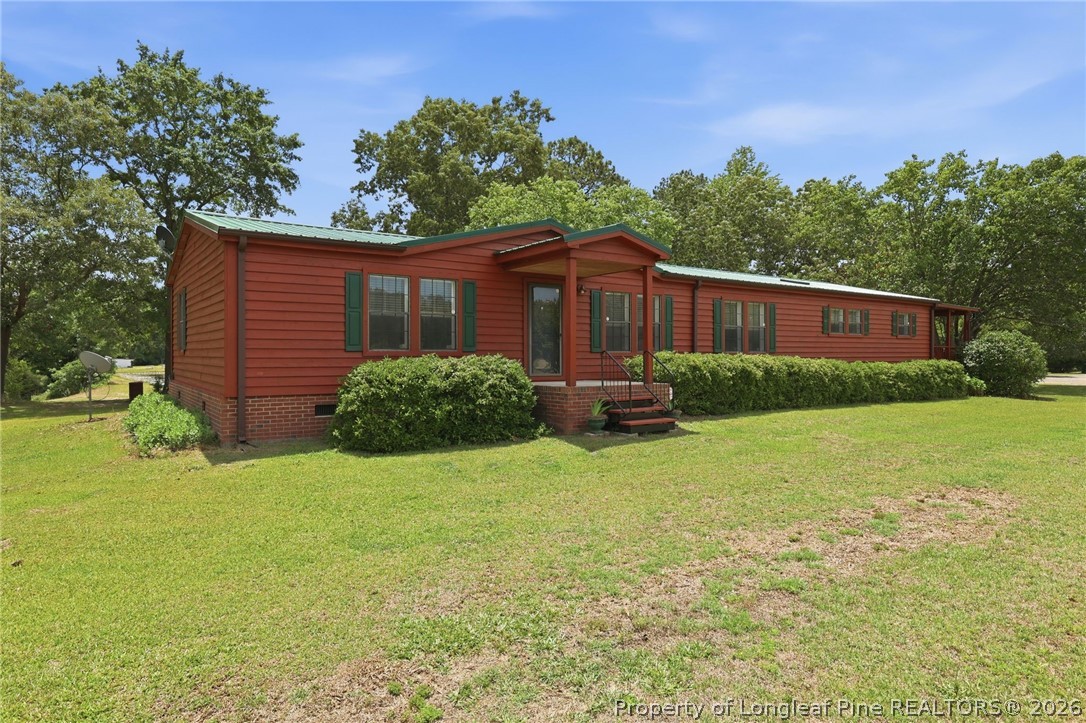 10400 Ruth Vinson Road Autryville, NC 28318 - Photo 15 of 49 a backyard of a house with lots of green space