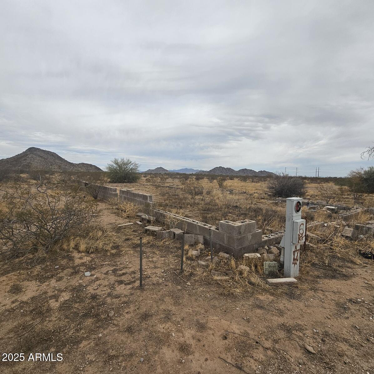 7640 North La Burma Road Maricopa, AZ 85139 - Photo 16 of 20 a view of a dry yard with mountains in the background