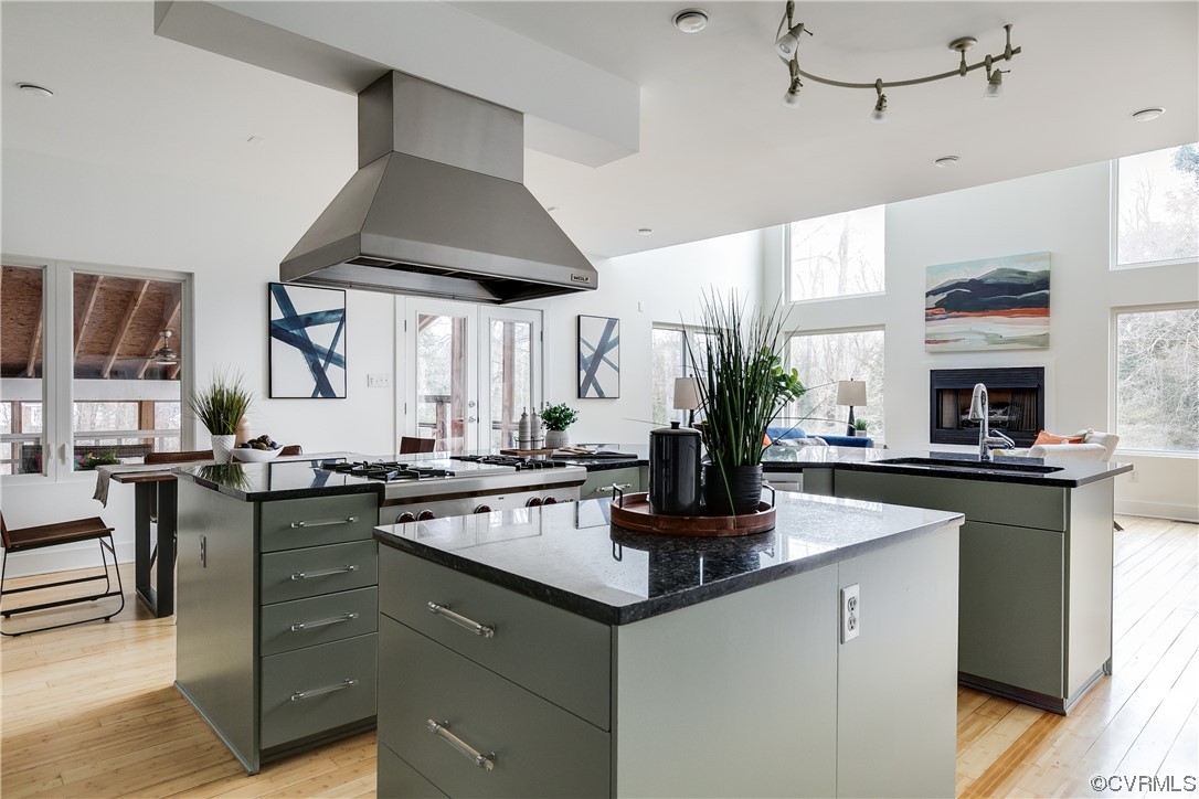8312 Gwinnett Road Henrico, VA 23229 - Photo 15 of 50 a kitchen with stainless steel appliances granite countertop a sink a stove and a wooden floors
