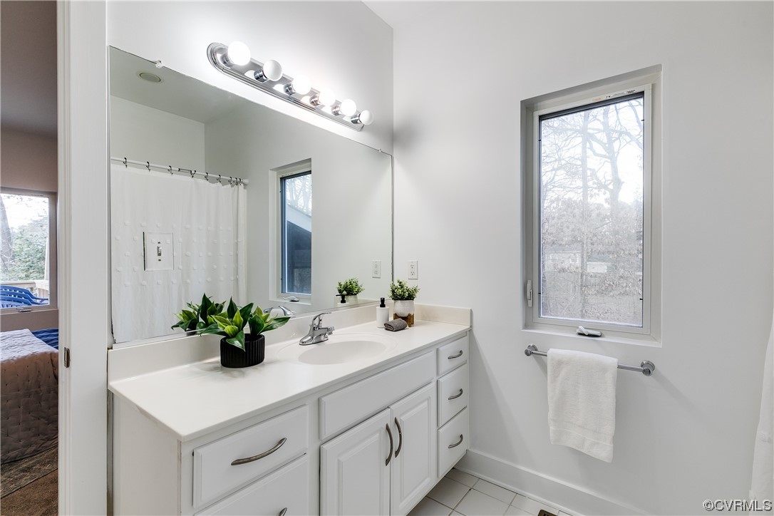 8312 Gwinnett Road Henrico, VA 23229 - Photo 19 of 50 a bathroom with a sink a vanity and a mirror