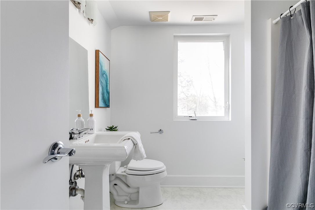 8312 Gwinnett Road Henrico, VA 23229 - Photo 34 of 50 a bathroom with a sink mirror and toilet