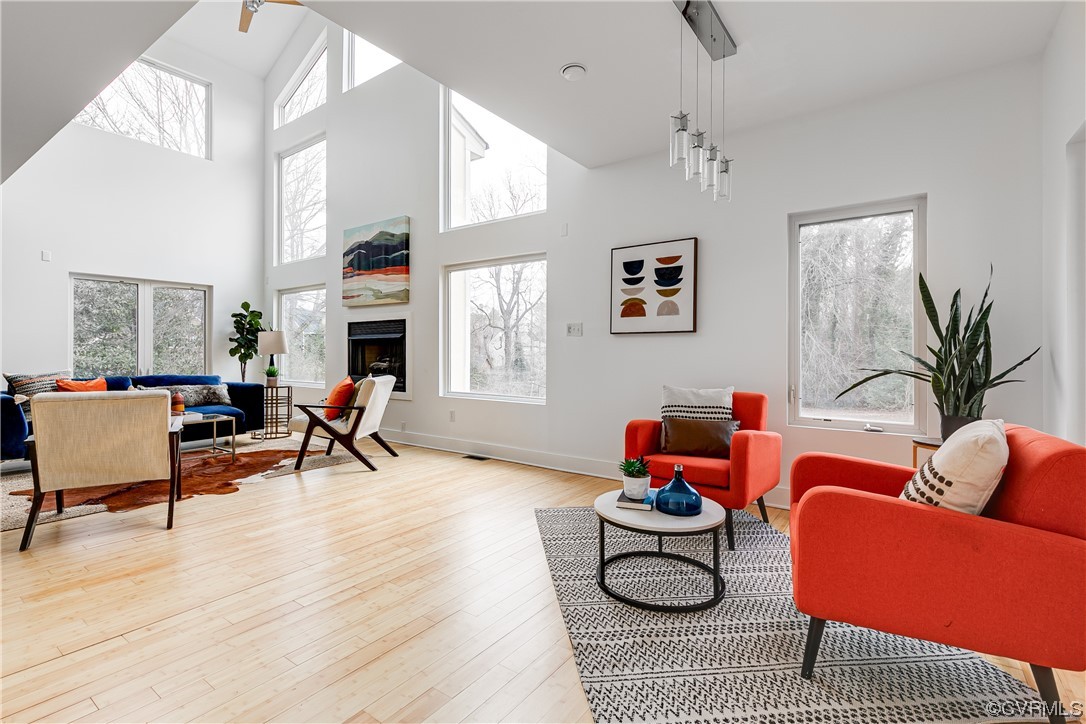 8312 Gwinnett Road Henrico, VA 23229 - Photo 5 of 50 a living room with furniture a fireplace and a chandelier