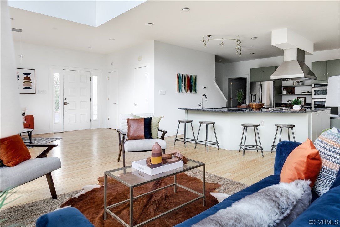 8312 Gwinnett Road Henrico, VA 23229 - Photo 9 of 50 a living room with furniture and kitchen view