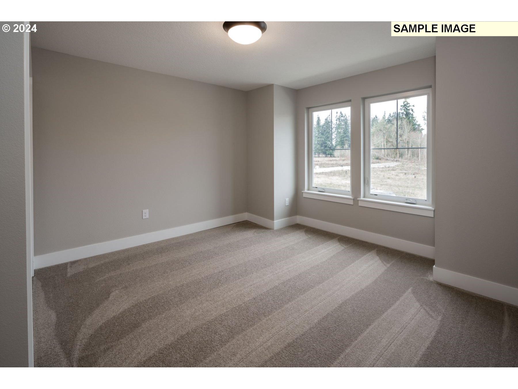 1018 South 46th Place Ridgefield, WA 98642 - Photo 15 of 34 a view of an empty room with wooden floor and a window