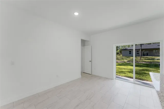 a view of an empty room with glass door