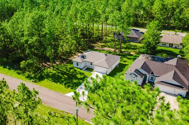 an aerial view of a house with yard swimming pool and outdoor seating