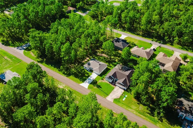 an aerial view of a house with a yard and garden