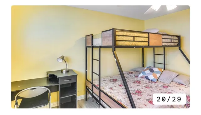 a bedroom with a bed and flat screen tv