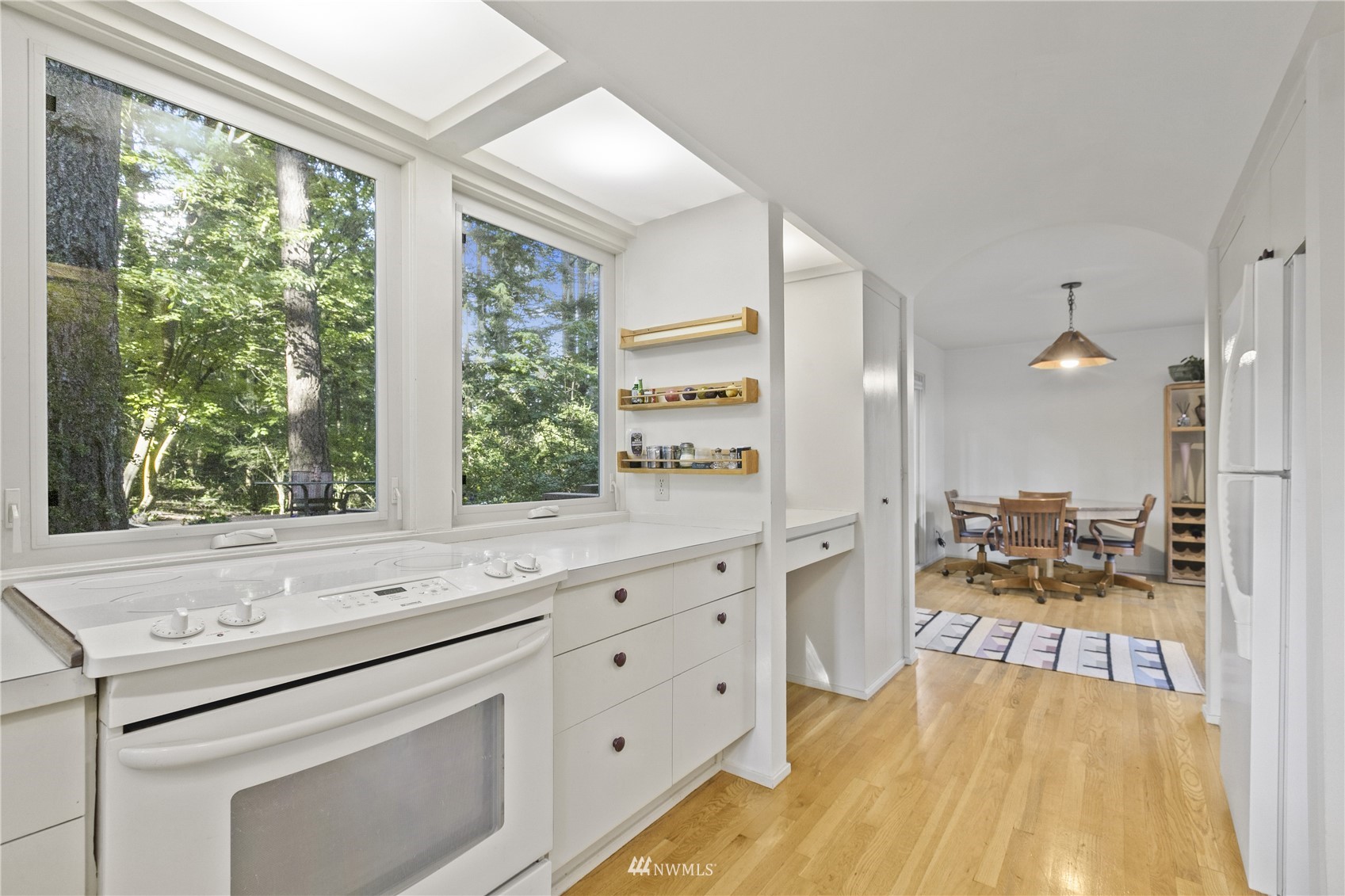 621 Willow Road Bellingham, WA 98225 - Photo 11 of 33 a open kitchen with white cabinets and wooden floor