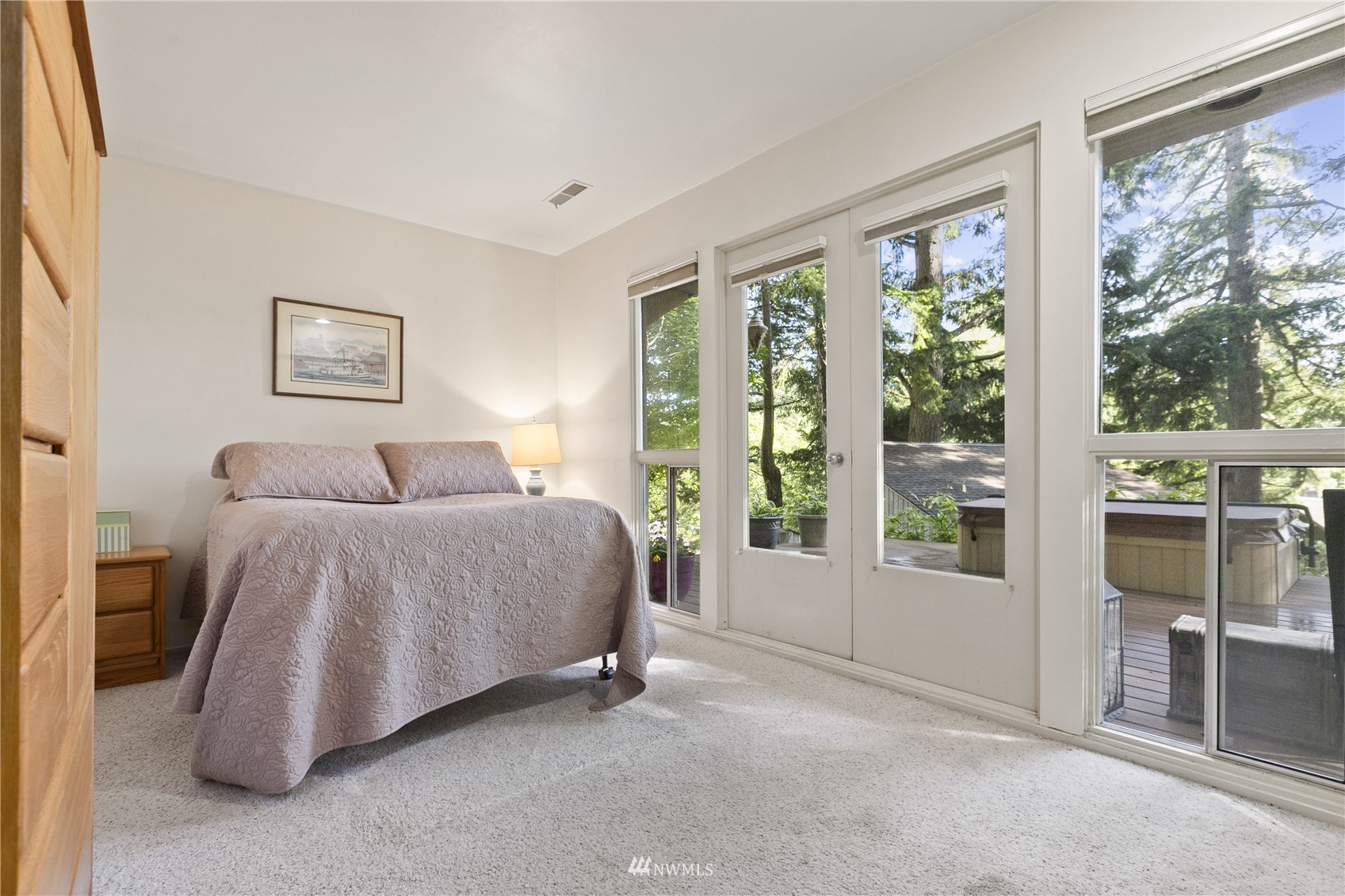 621 Willow Road Bellingham, WA 98225 - Photo 19 of 33 a spacious bedroom with a bed and glass door
