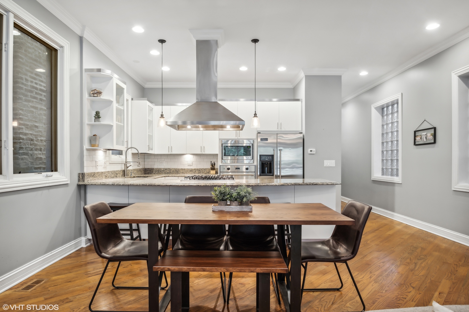 1131 West Addison Street, Unit 1 Chicago, IL 60613 - Photo 11 of 27 a kitchen with a table chairs stove and cabinets