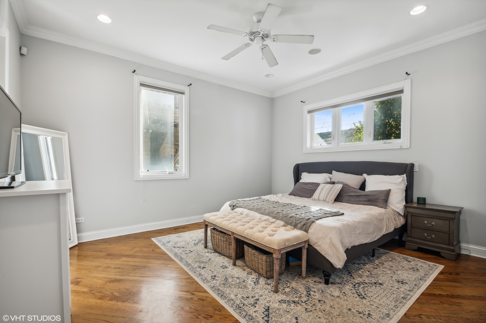 1131 West Addison Street, Unit 1 Chicago, IL 60613 - Photo 16 of 27 a bedroom with a bed and wooden floor