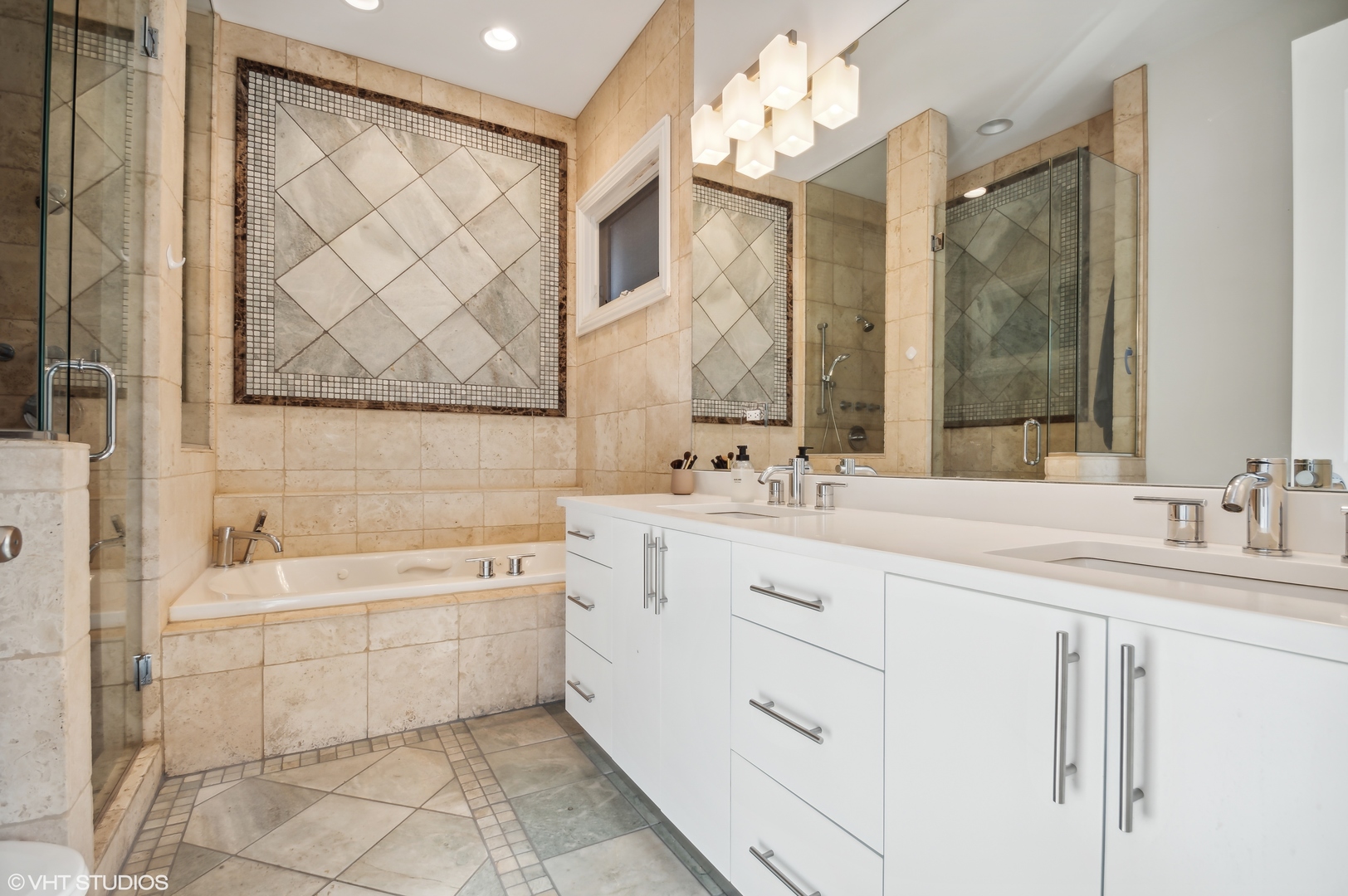 1131 West Addison Street, Unit 1 Chicago, IL 60613 - Photo 17 of 27 a bathroom with a double vanity sink mirror and a bathtub