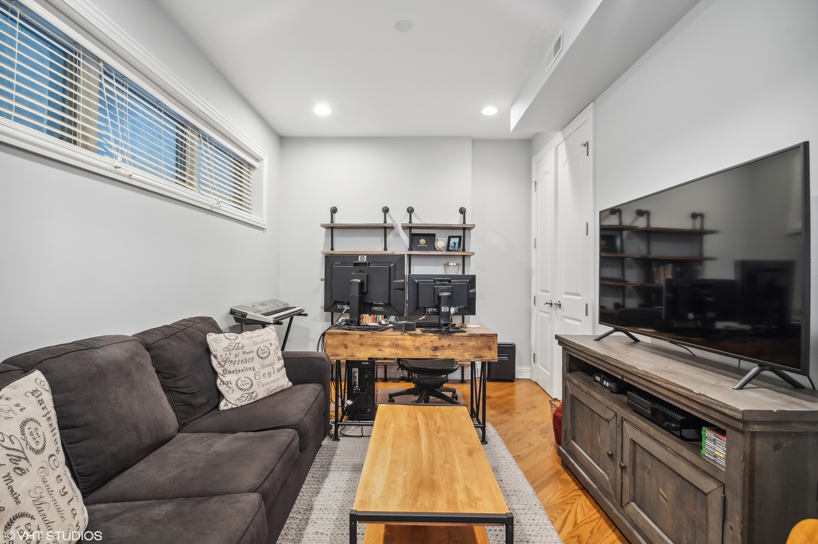 1131 West Addison Street, Unit 1 Chicago, IL 60613 - Photo 20 of 27 a living room with furniture and a flat screen tv