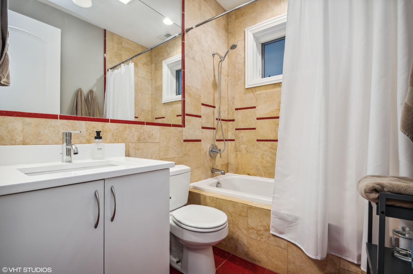 1131 West Addison Street, Unit 1 Chicago, IL 60613 - Photo 21 of 27 a bathroom with a sink toilet and shower