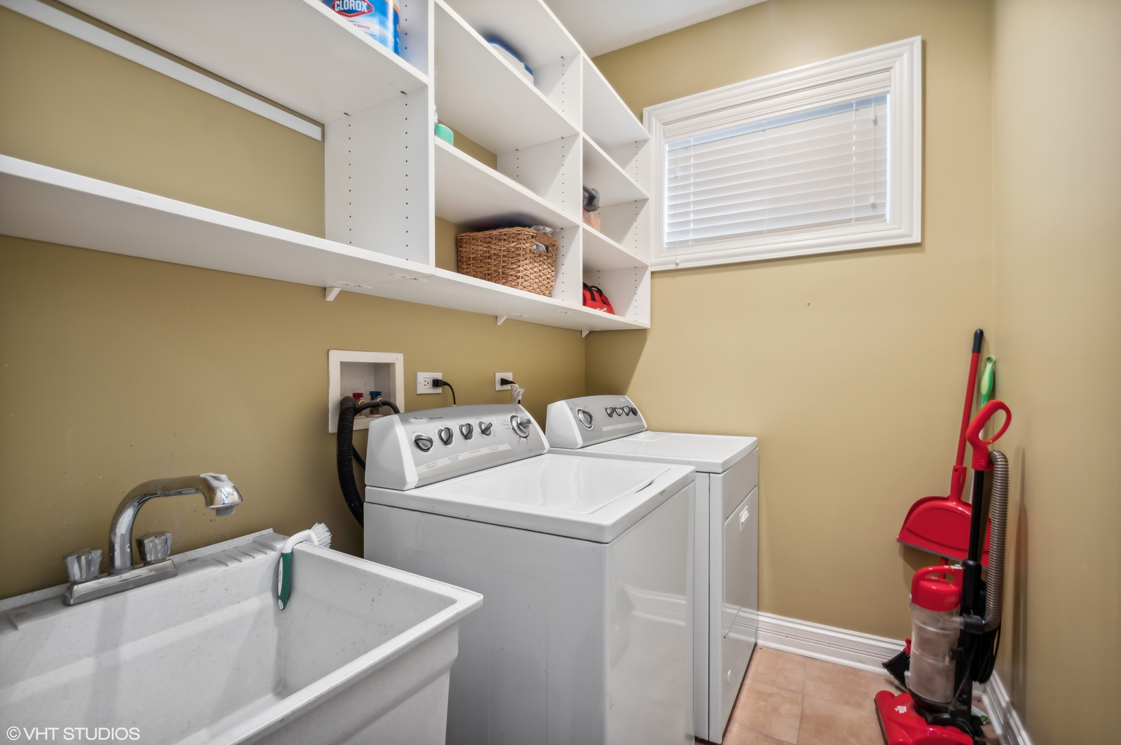 1131 West Addison Street, Unit 1 Chicago, IL 60613 - Photo 22 of 27 a bathroom with a sink a washer and dryer