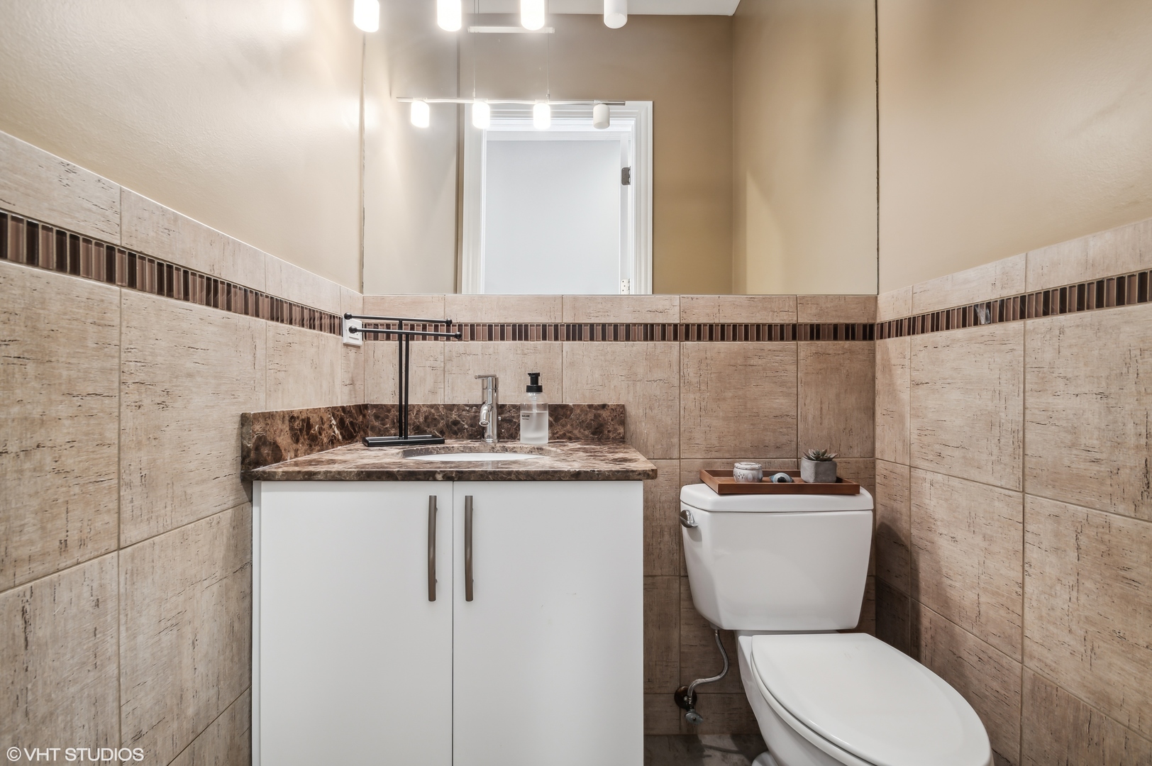 1131 West Addison Street, Unit 1 Chicago, IL 60613 - Photo 23 of 27 a bathroom with a granite countertop toilet sink and mirror