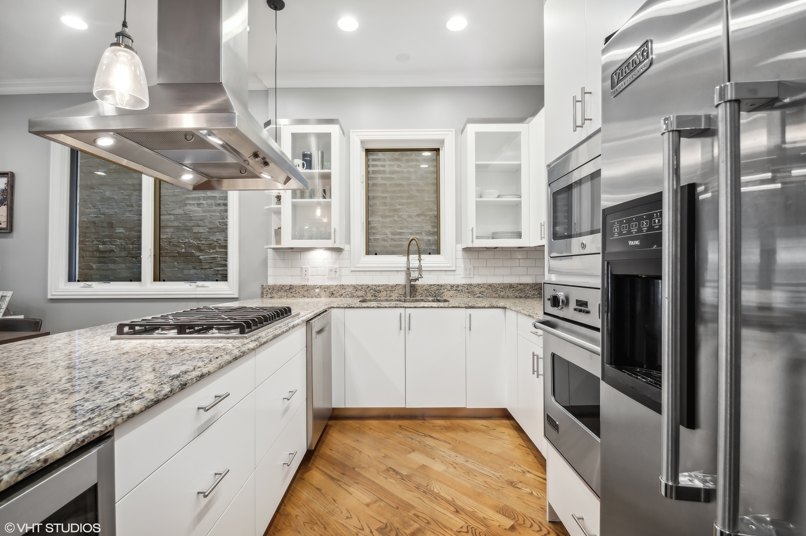 1131 West Addison Street, Unit 1 Chicago, IL 60613 - Photo 9 of 27 a kitchen with stainless steel appliances granite countertop a sink stove and refrigerator