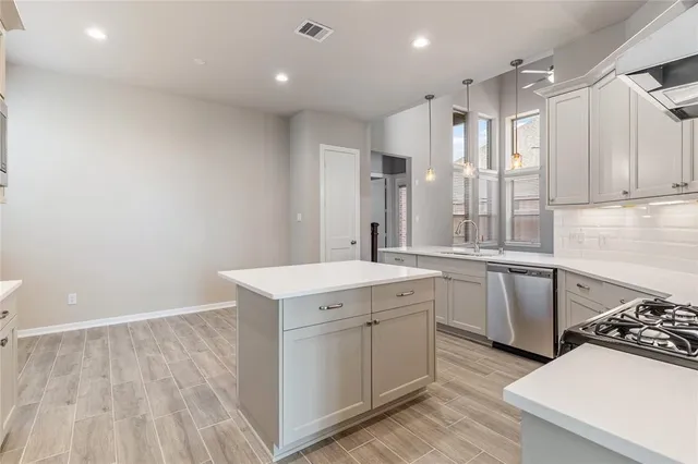 a kitchen with a sink stove and cabinets