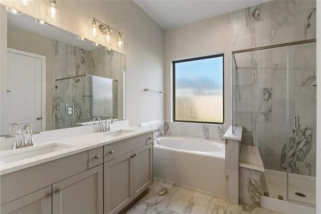 a bathroom with a double vanity sink mirror and shower