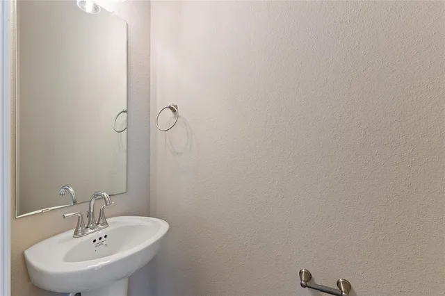 a bathroom with a sink and mirror