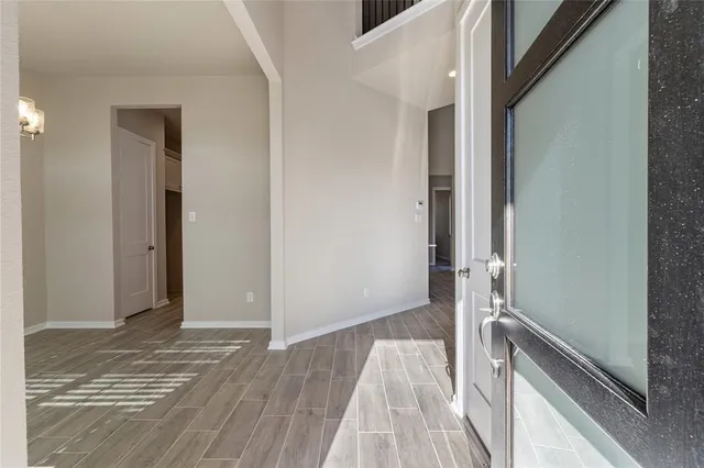 a view of a room with wooden floor and staircase