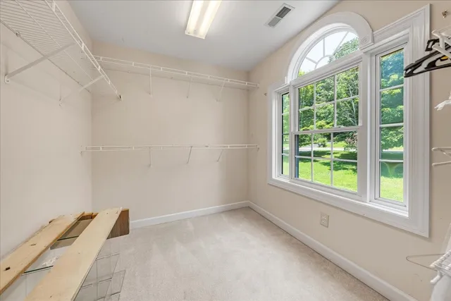a backyard of a house with a fountain table and chairs
