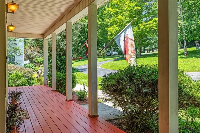 a view of a room with wooden floor and a chandelier