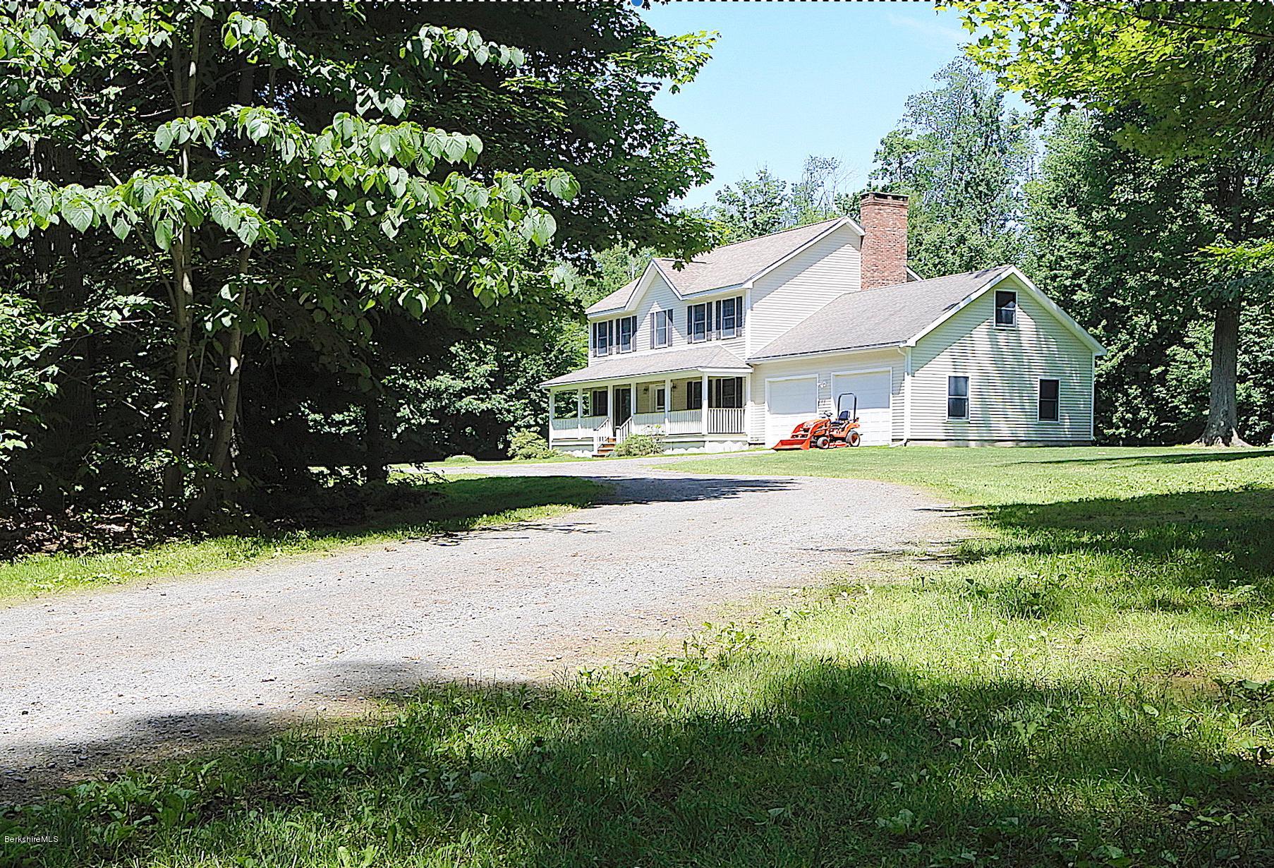 24 Housatonnuck Road Stockbridge, MA 01262 - Photo 1 of 36 a view of a house with a big yard and large trees