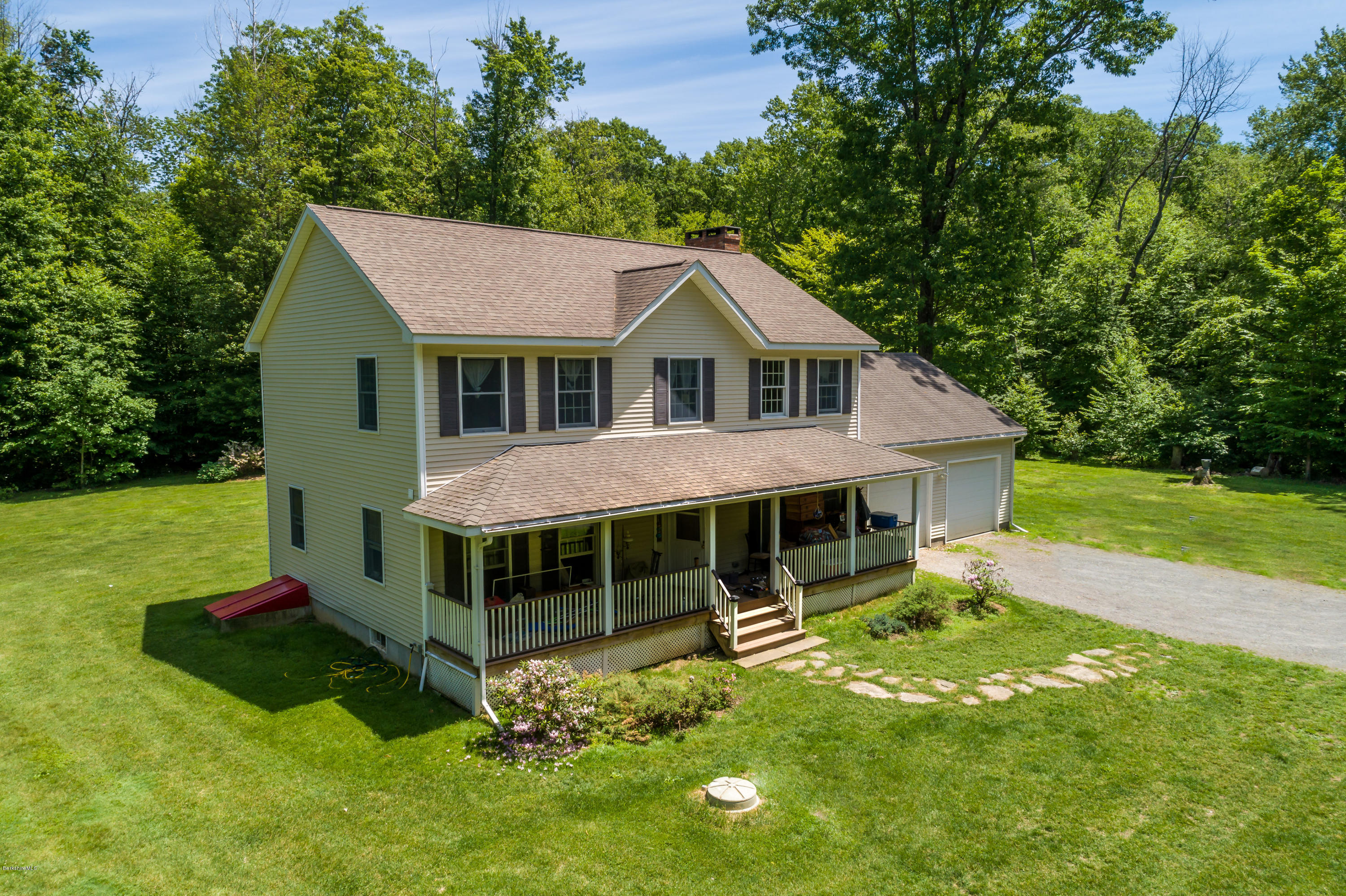 24 Housatonnuck Road Stockbridge, MA 01262 - Photo 2 of 36 a front view of a house with a yard table and chairs
