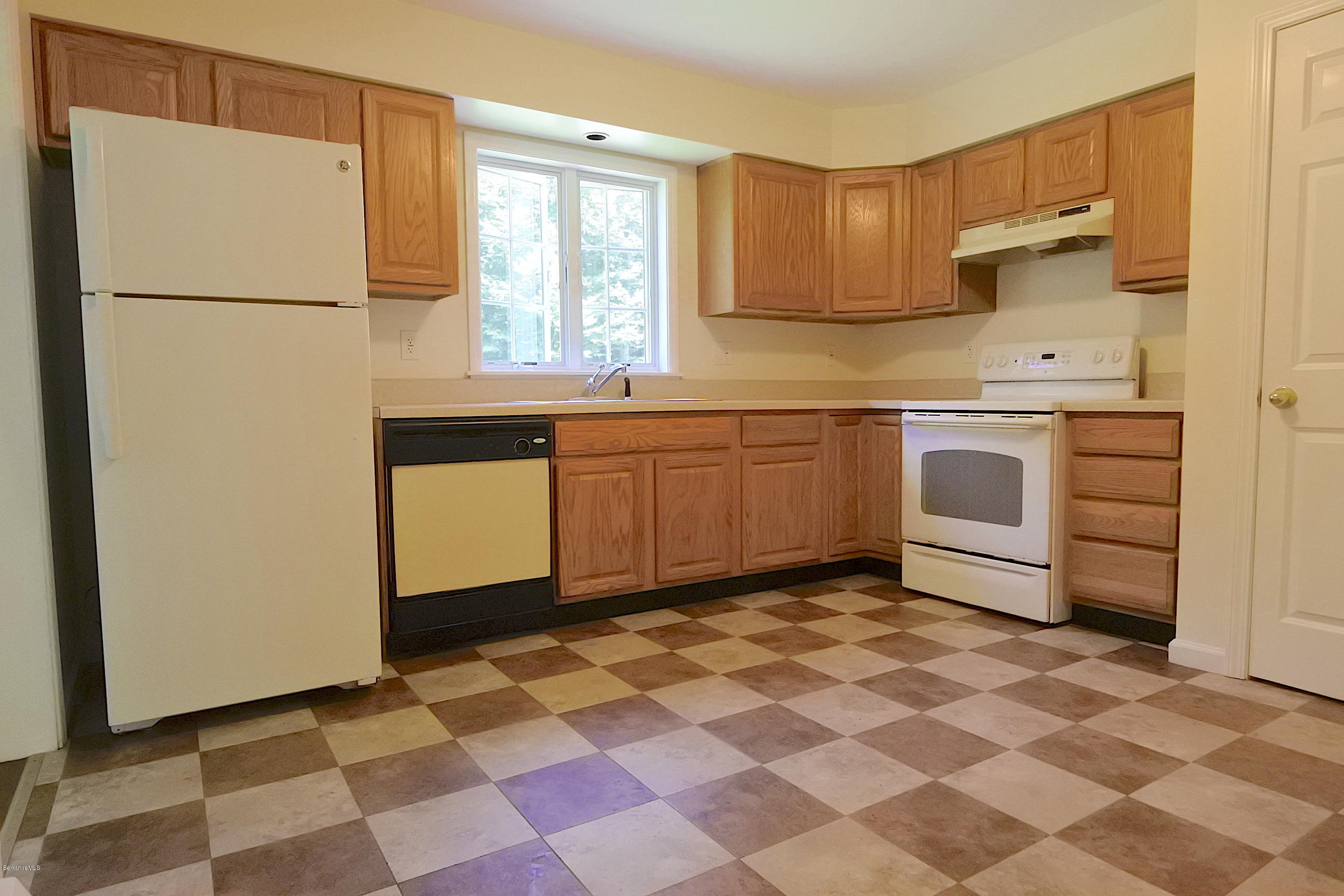 24 Housatonnuck Road Stockbridge, MA 01262 - Photo 11 of 36 a kitchen with stainless steel appliances granite countertop a refrigerator sink and cabinets
