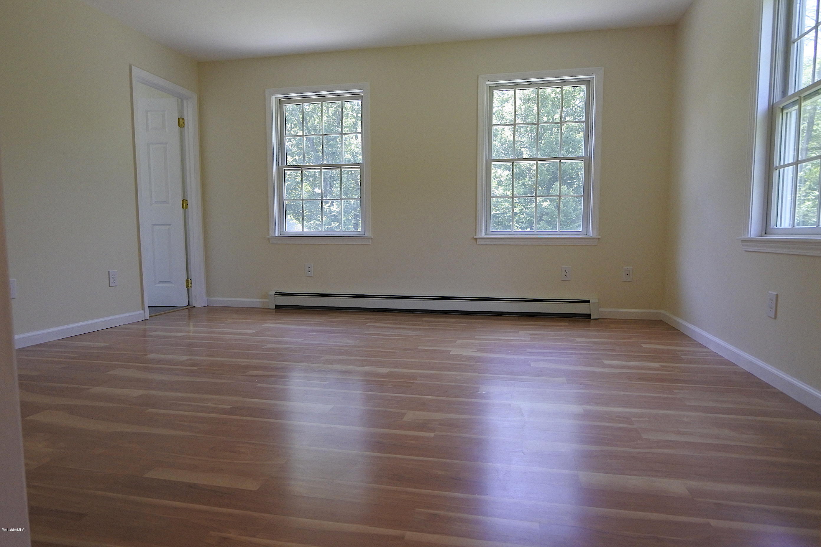 24 Housatonnuck Road Stockbridge, MA 01262 - Photo 14 of 36 an empty room with wooden floor and windows