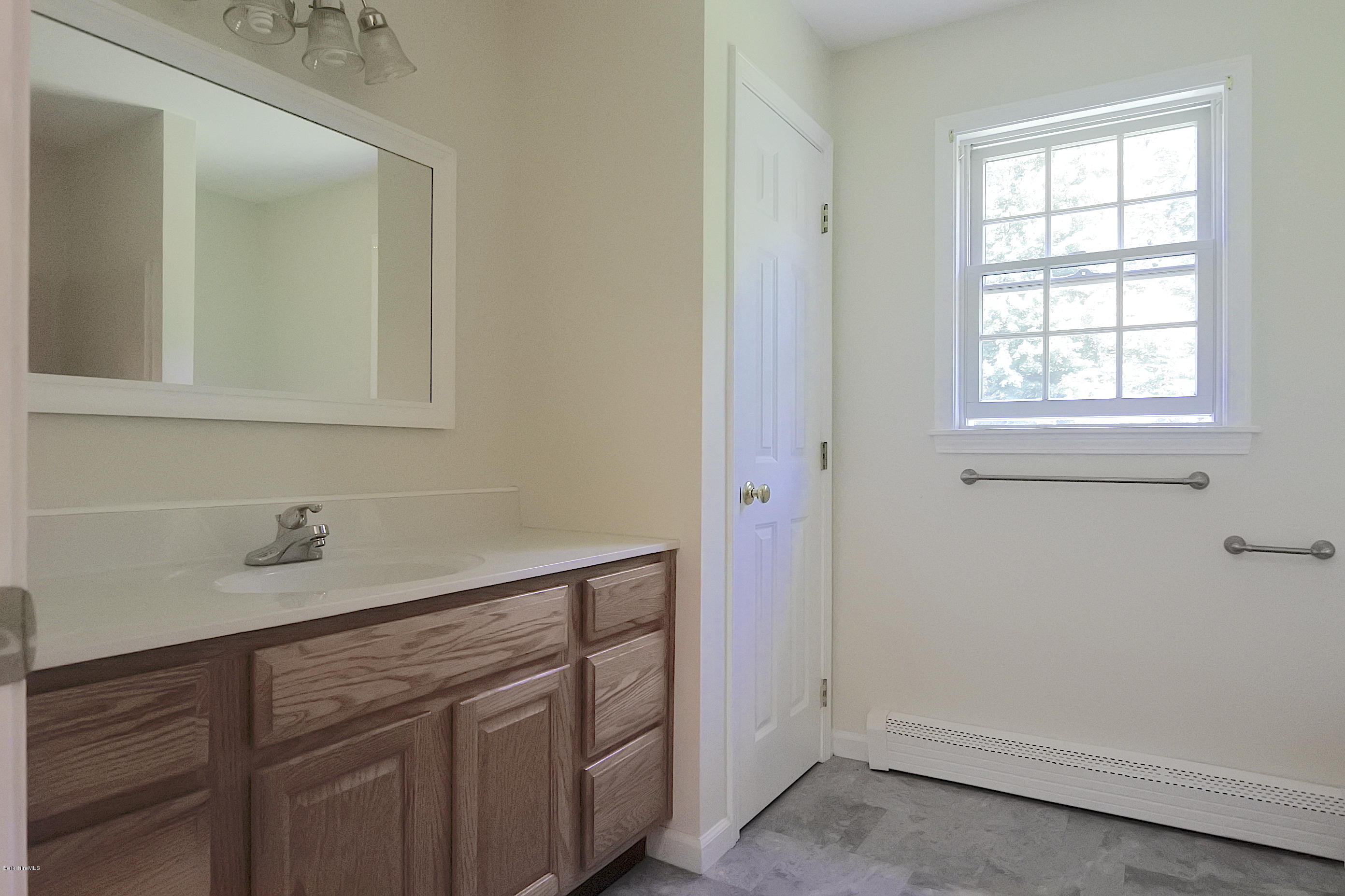24 Housatonnuck Road Stockbridge, MA 01262 - Photo 15 of 36 a bathroom with a sink and cabinets