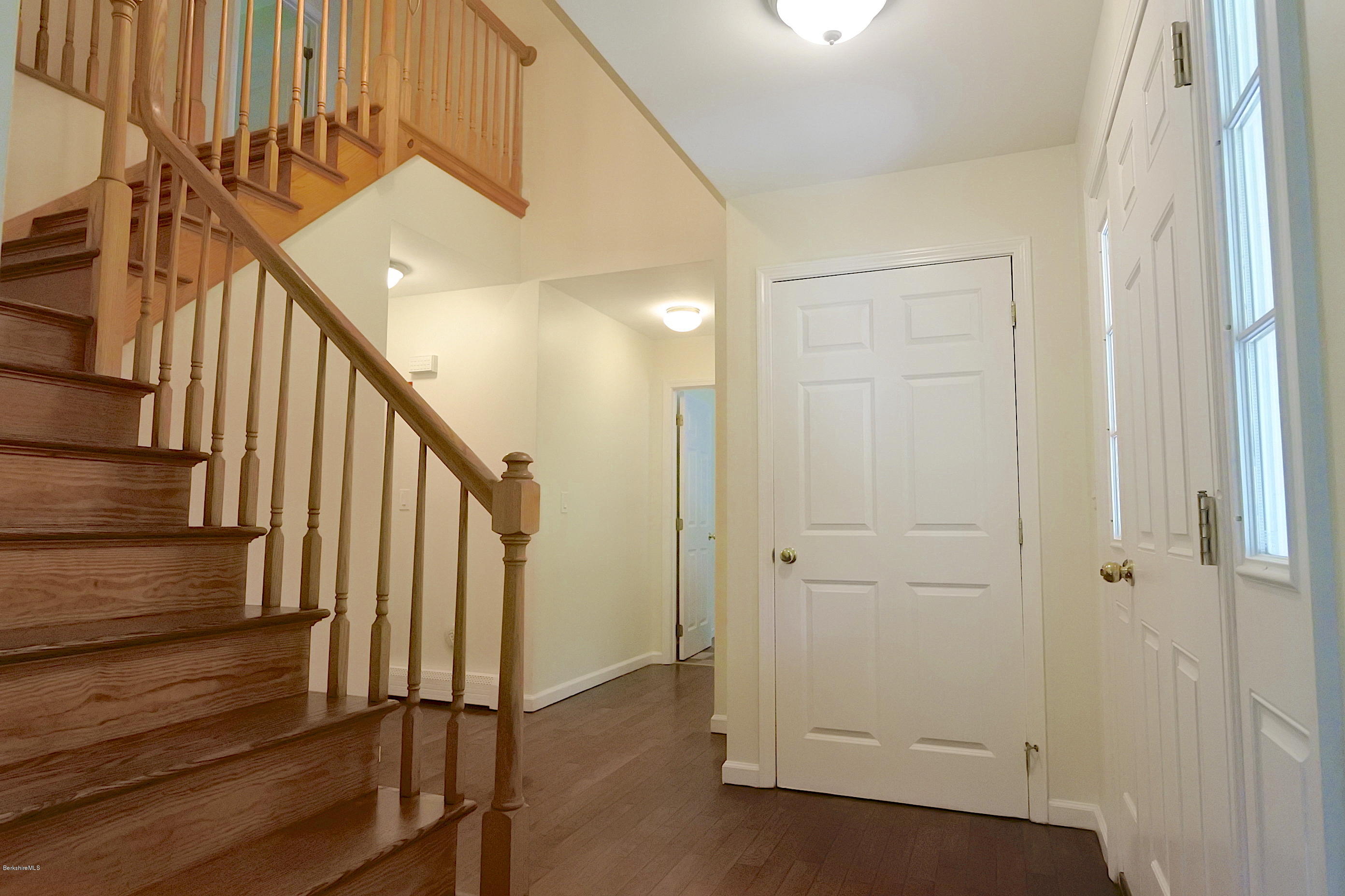 24 Housatonnuck Road Stockbridge, MA 01262 - Photo 8 of 36 a view of a hallway with wooden floor and staircase