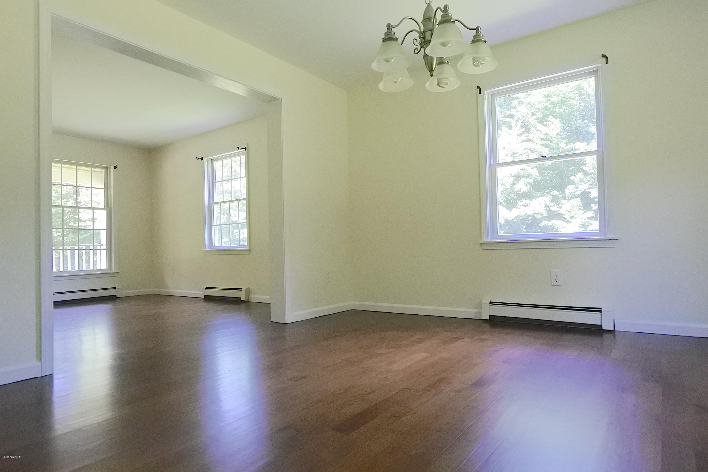24 Housatonnuck Road Stockbridge, MA 01262 - Photo 10 of 36 a view of an empty room with wooden floor and a window