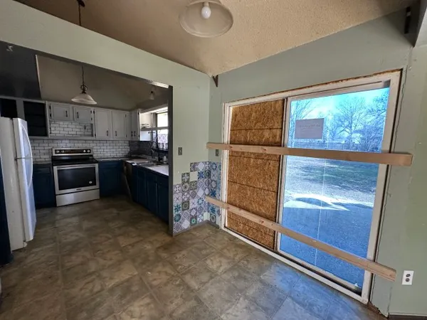 a kitchen with a sink stove and microwave