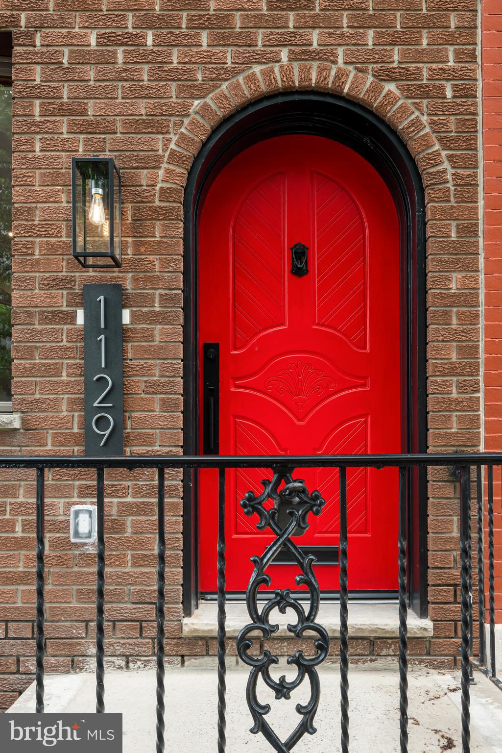 1129 South 12th Street Philadelphia, PA 19147 - Photo 1 of 24 a view of a red brick building with red door