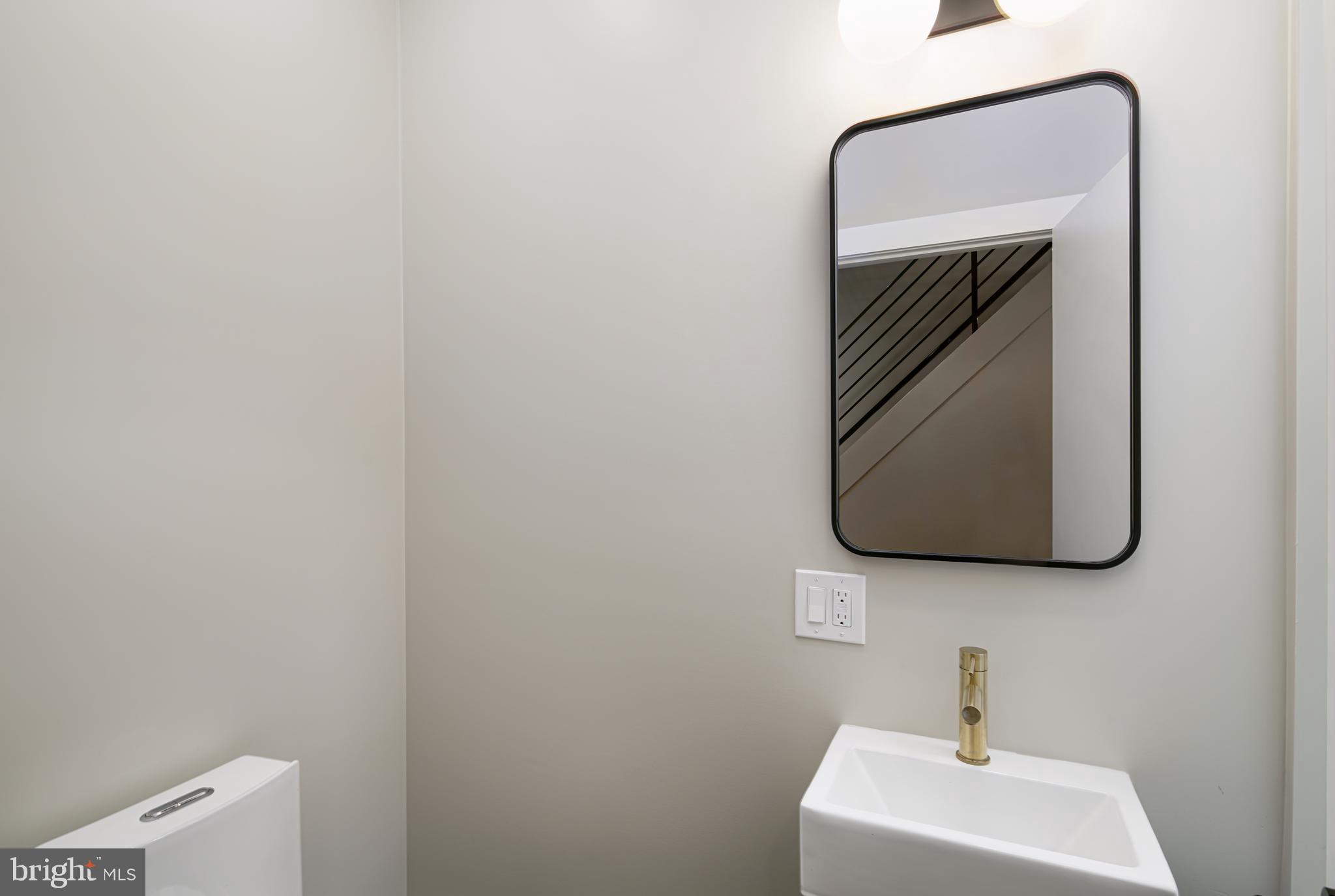 1129 South 12th Street Philadelphia, PA 19147 - Photo 13 of 24 a bathroom with a toilet and mirror