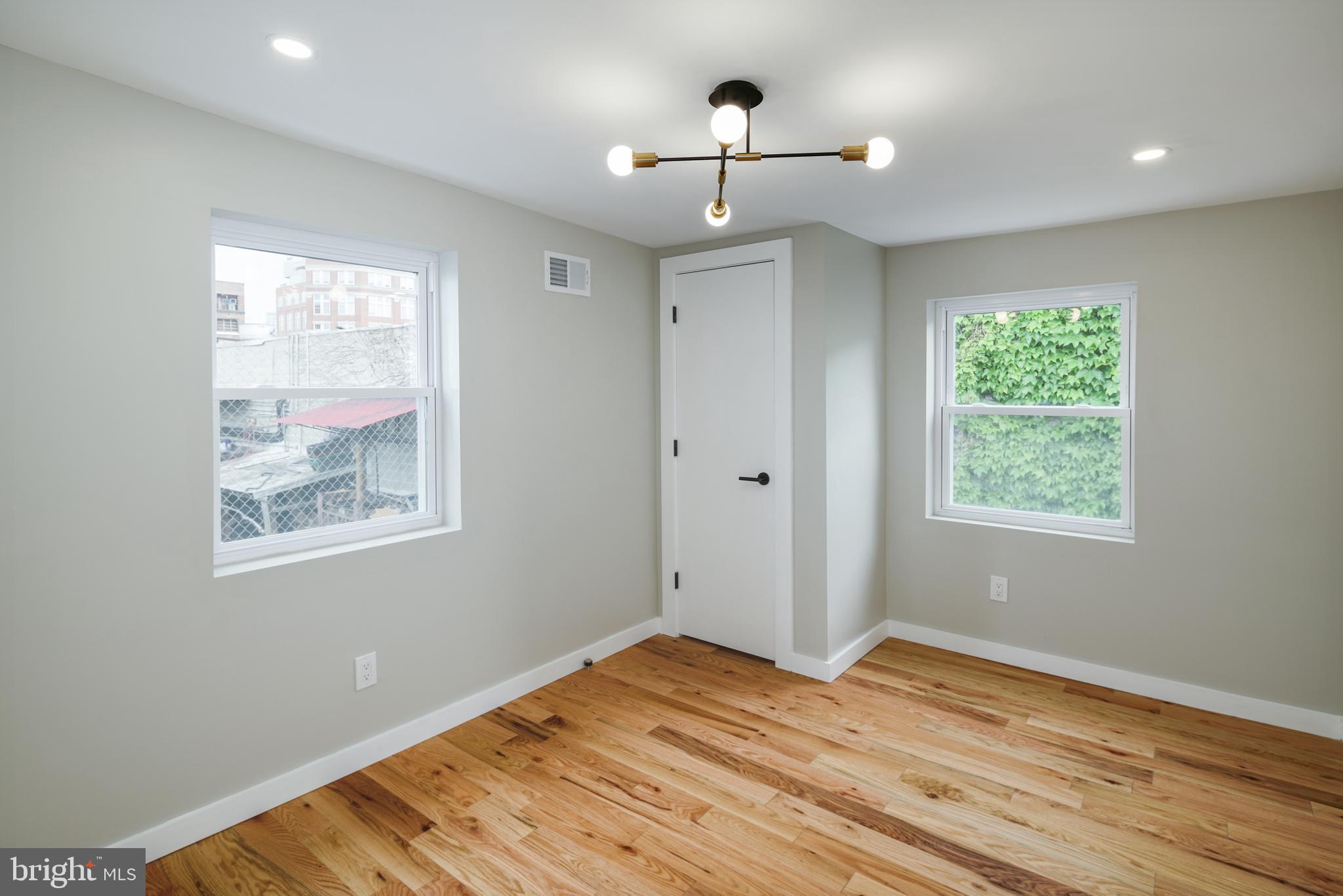 1129 South 12th Street Philadelphia, PA 19147 - Photo 19 of 24 a view of empty room with window and wooden floor