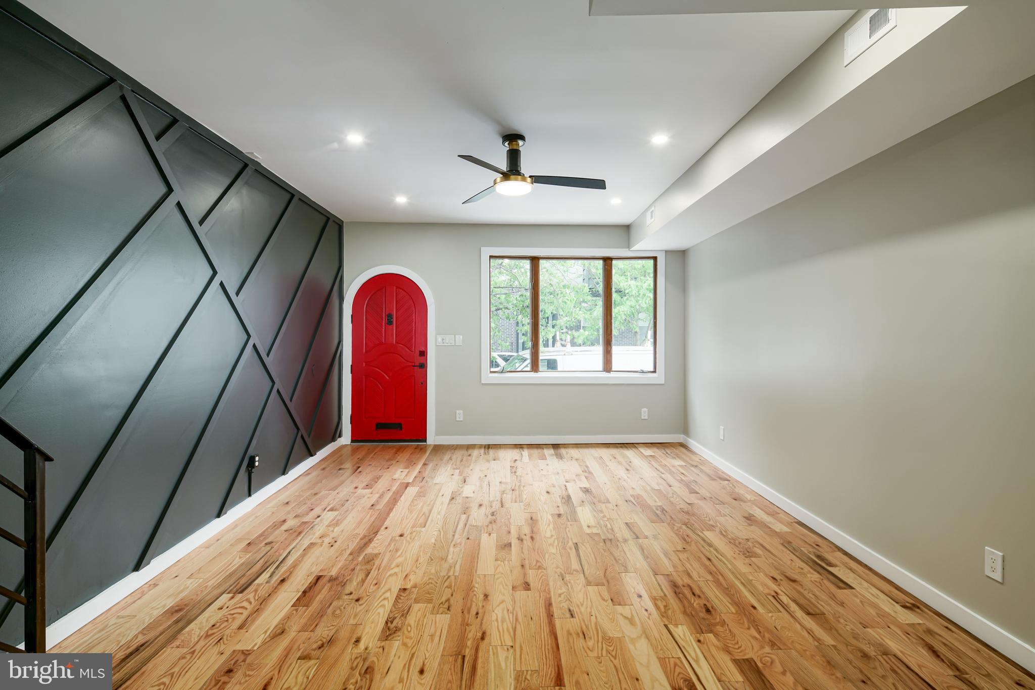 1129 South 12th Street Philadelphia, PA 19147 - Photo 2 of 24 a view of a room with wooden floor chandelier and windows