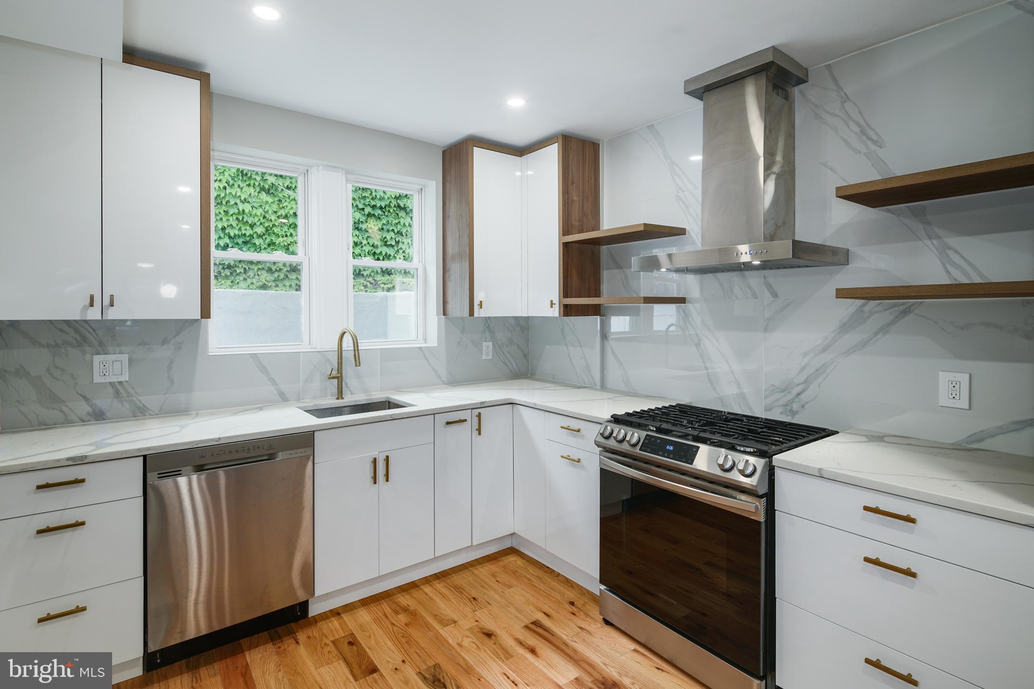 1129 South 12th Street Philadelphia, PA 19147 - Photo 7 of 24 a kitchen with a sink stove top oven and cabinets