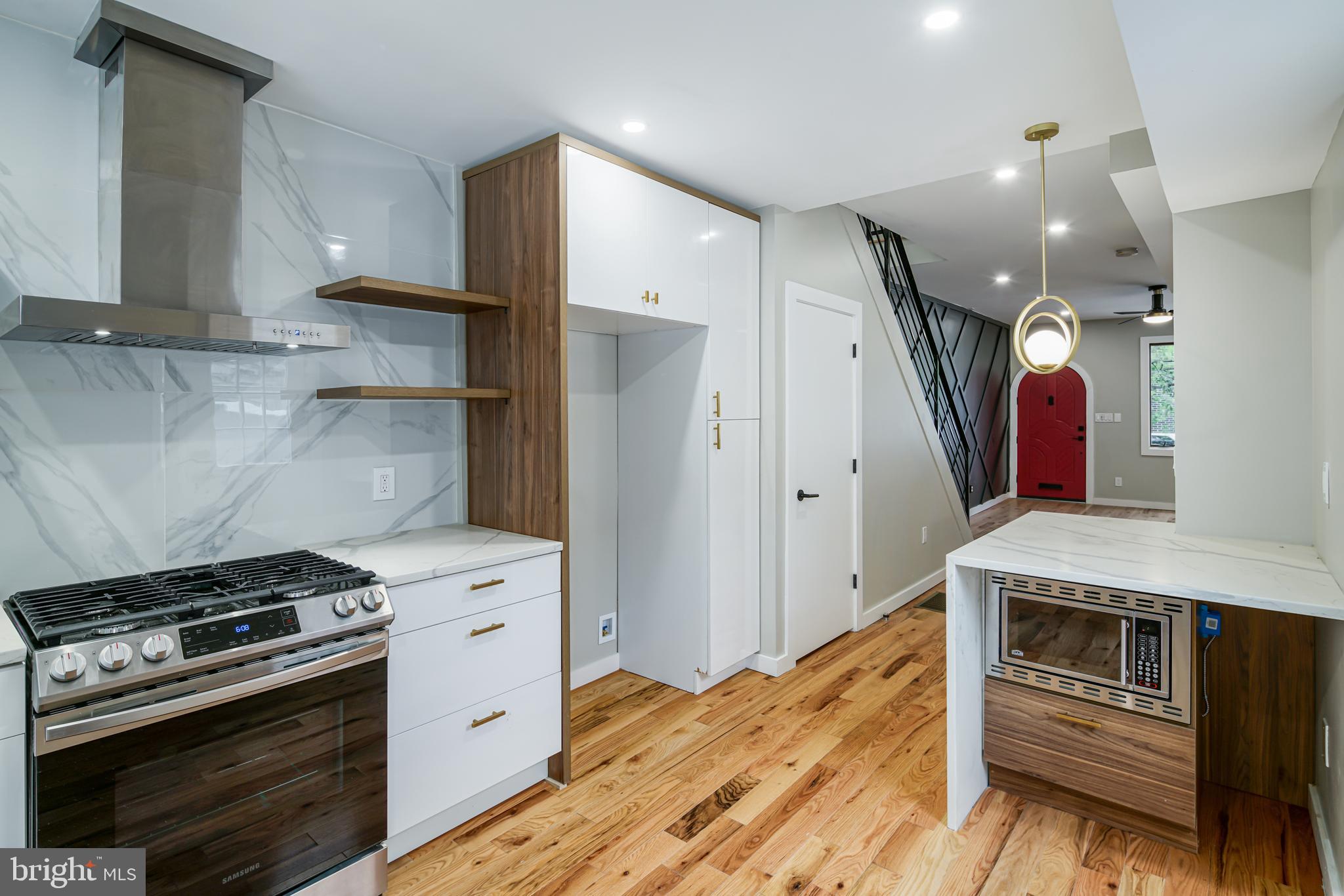 1129 South 12th Street Philadelphia, PA 19147 - Photo 8 of 24 a kitchen with stainless steel appliances granite countertop a stove and a refrigerator