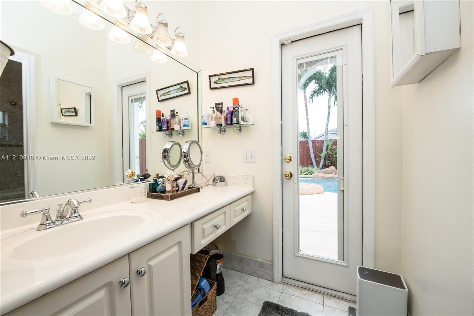 18226 Southwest 145th Avenue Miami, FL 33177 - Photo 15 of 30 a bathroom with a granite countertop sink mirror and vanity