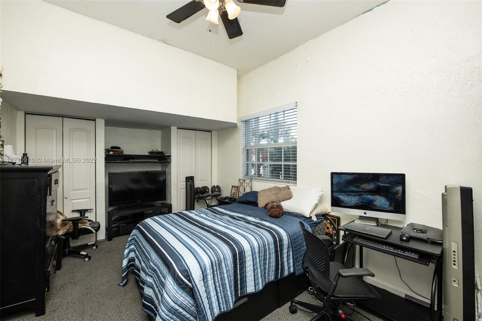 18226 Southwest 145th Avenue Miami, FL 33177 - Photo 19 of 30 a bedroom with a bed and a flat screen tv