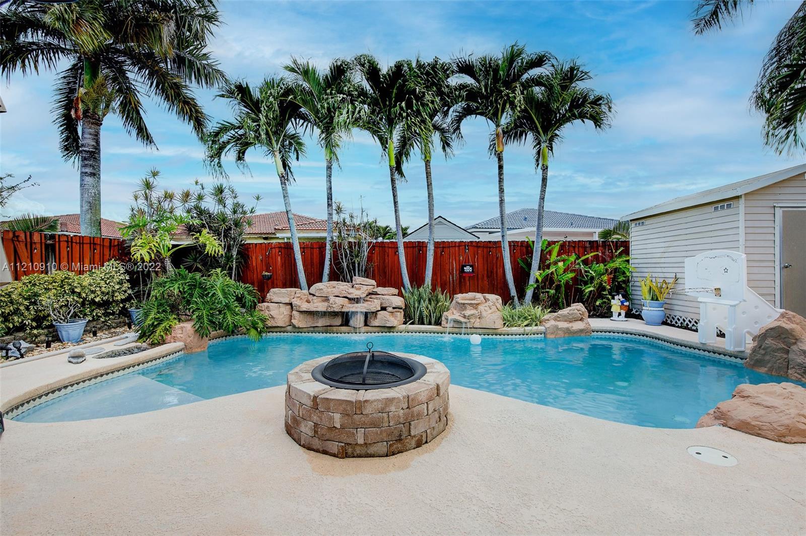 18226 Southwest 145th Avenue Miami, FL 33177 - Photo 21 of 30 a front view of house with yard and swimming pool