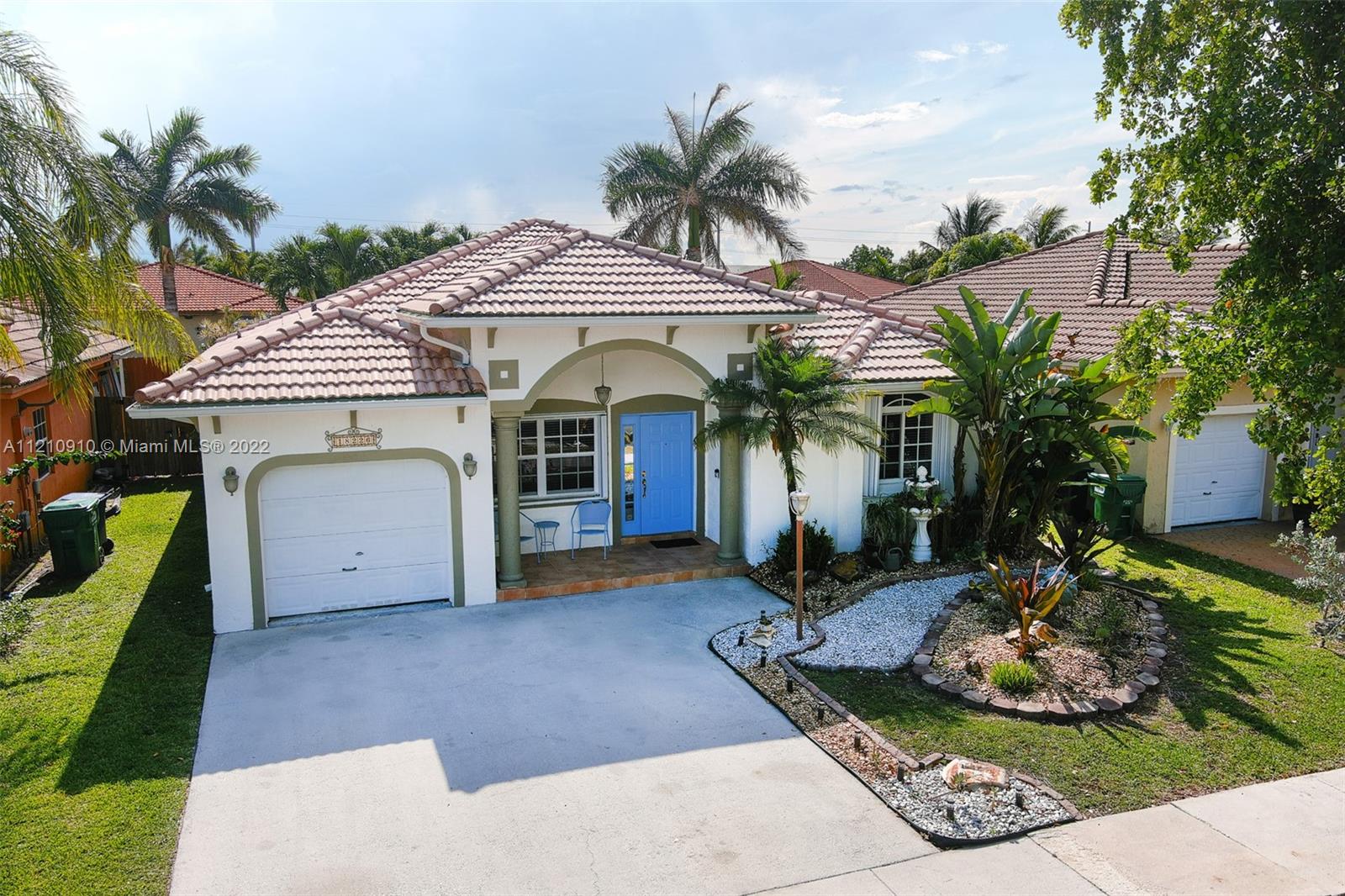 18226 Southwest 145th Avenue Miami, FL 33177 - Photo 25 of 30 a front view of a house with garden