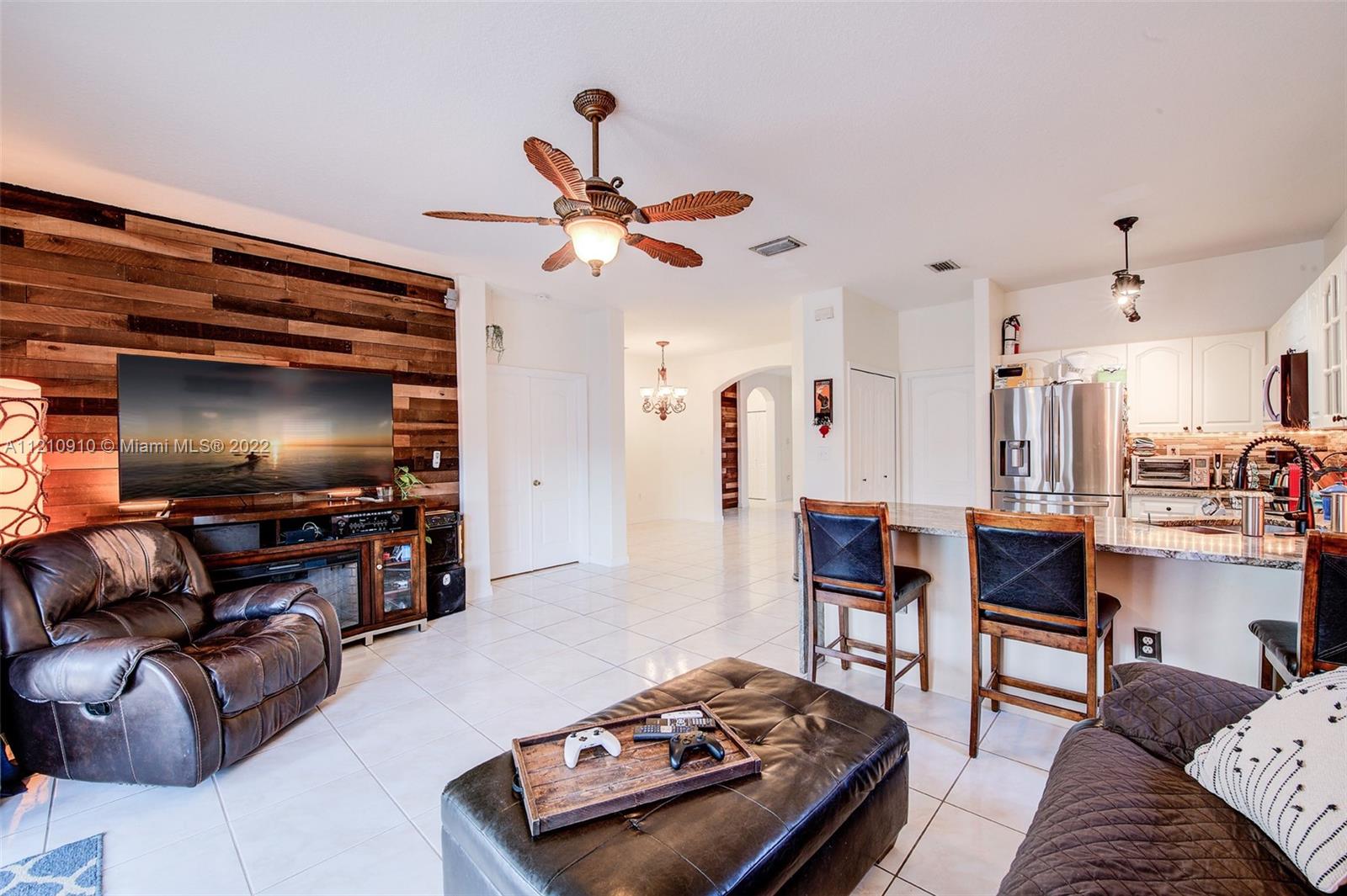 18226 Southwest 145th Avenue Miami, FL 33177 - Photo 10 of 30 a living room with furniture and a flat screen tv